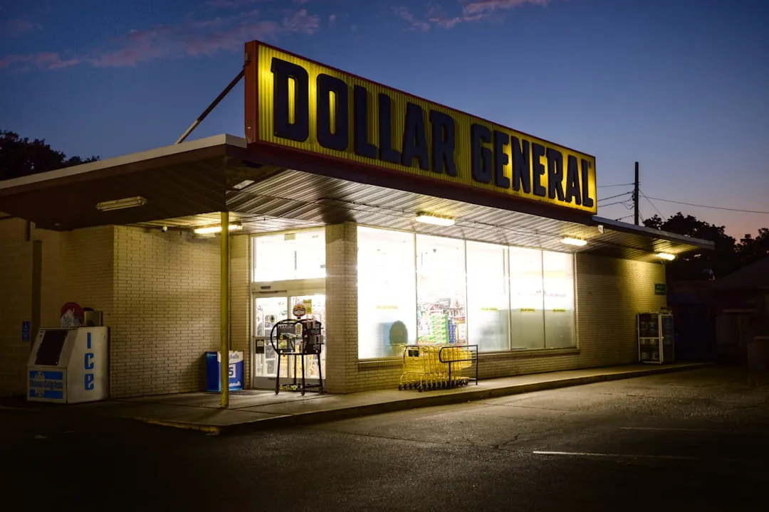 Exterior view of a grocery store and nearby gas station pump, representing major household spending categories