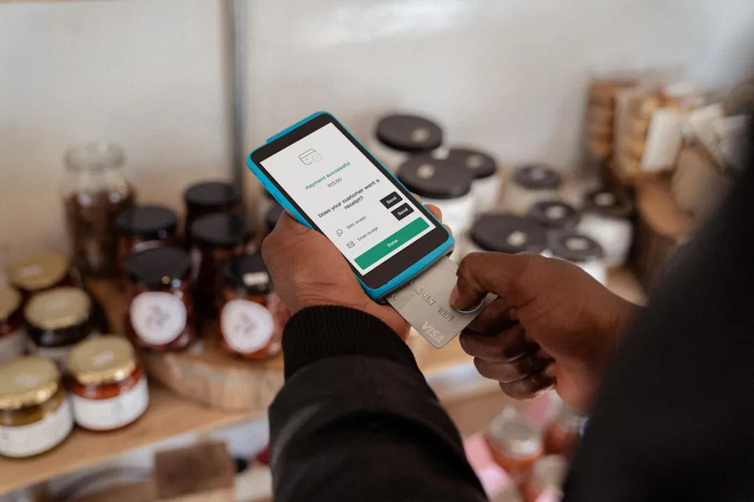Flat-lay arrangement of supermarket receipts, shopping bags, credit card, and category code reference sheet on neutral background