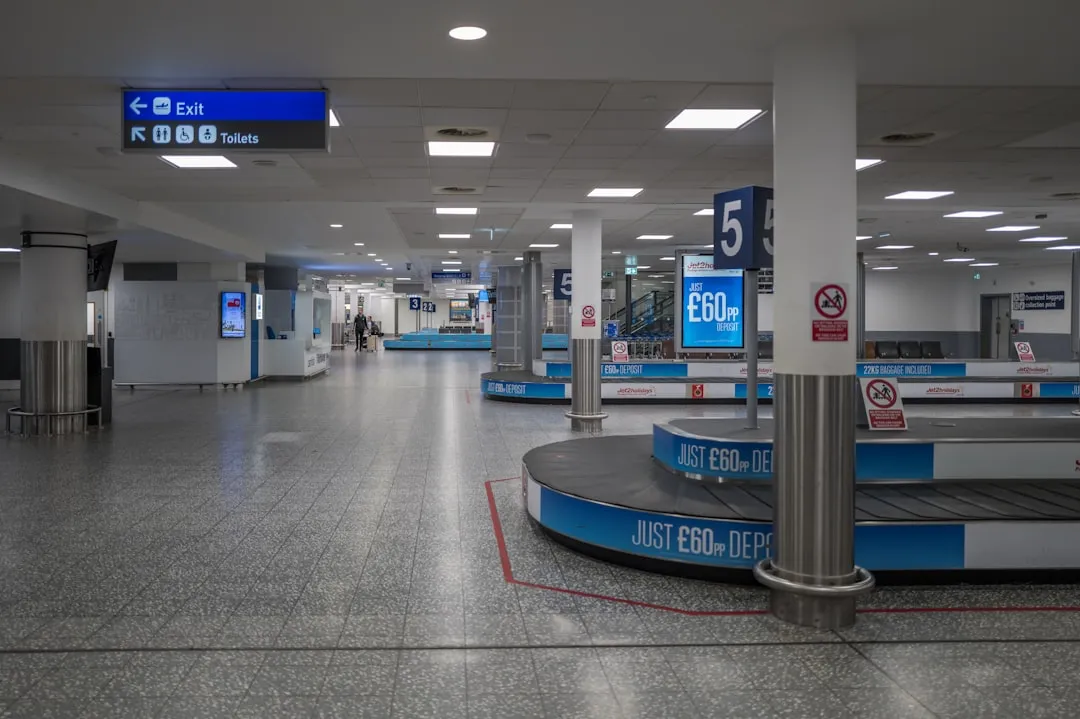 Passenger checking a bag at airline counter with suitcase on scale