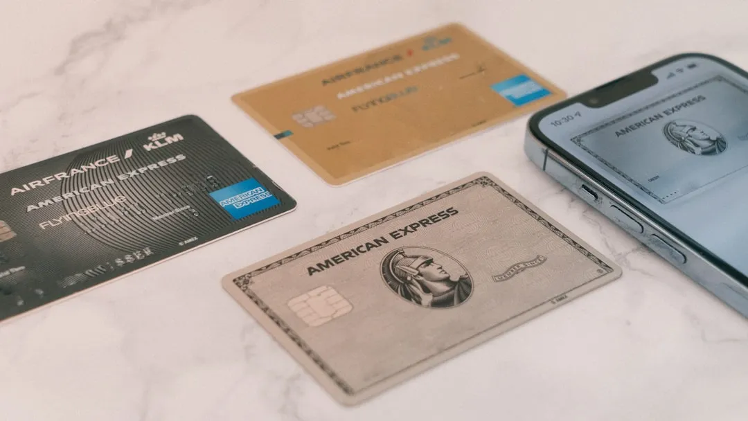 Several different airline credit cards and travel documents arranged on a table