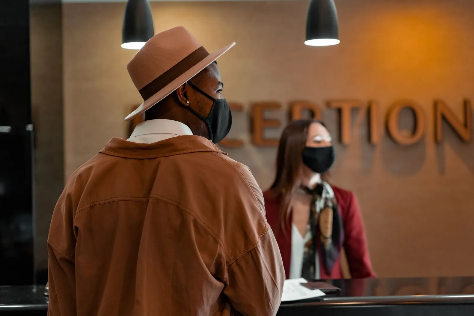 Hotel concierge greeting guest during check-in at front desk