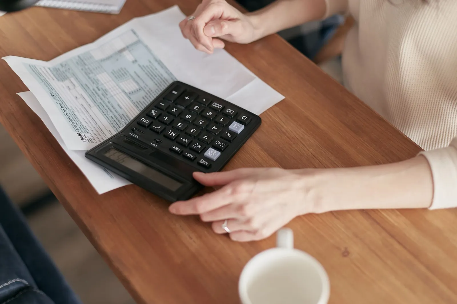 Desk setup with calculator and financial notes showing balance transfer interest savings