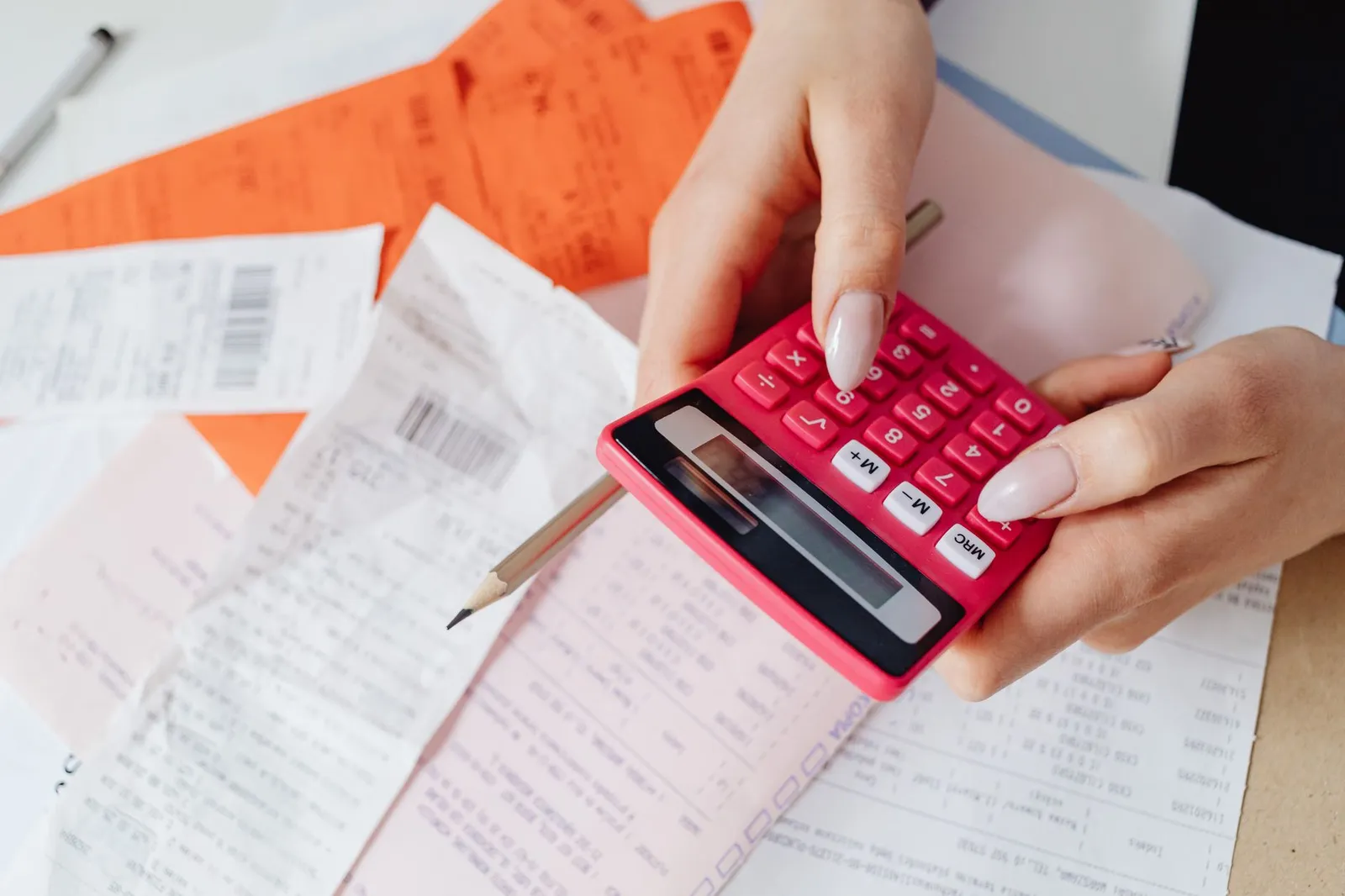 Calculator and financial documents showing debt repayment calculations