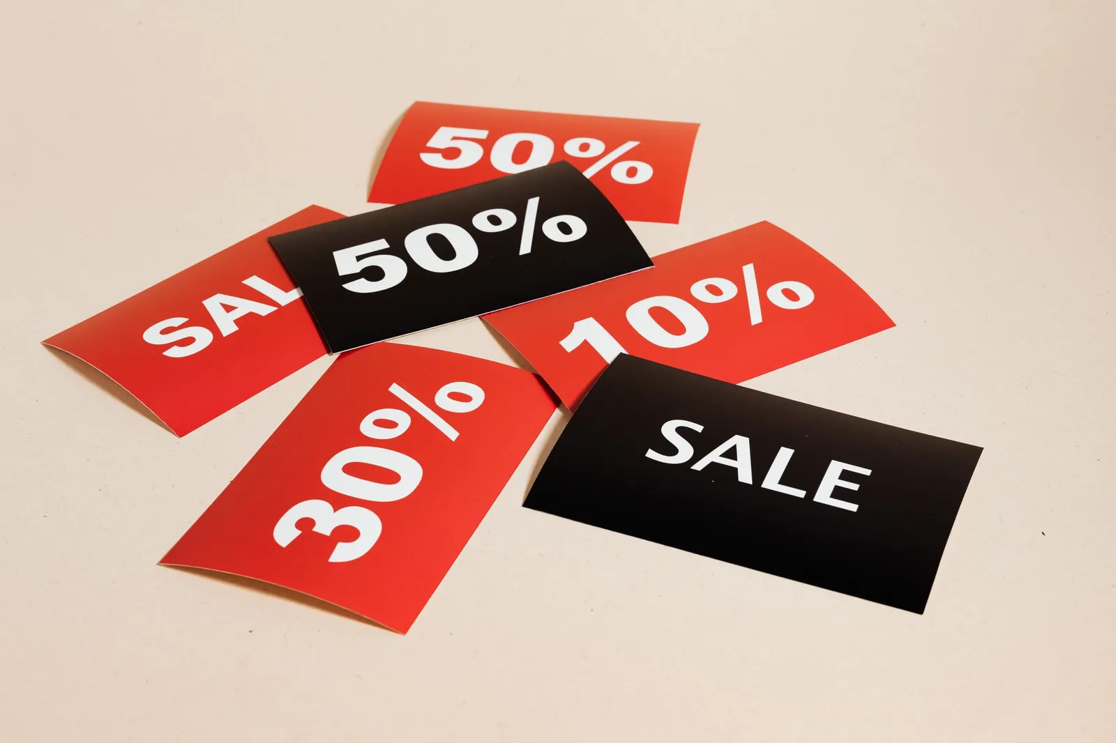 Two credit cards with balance amounts shown on paper below