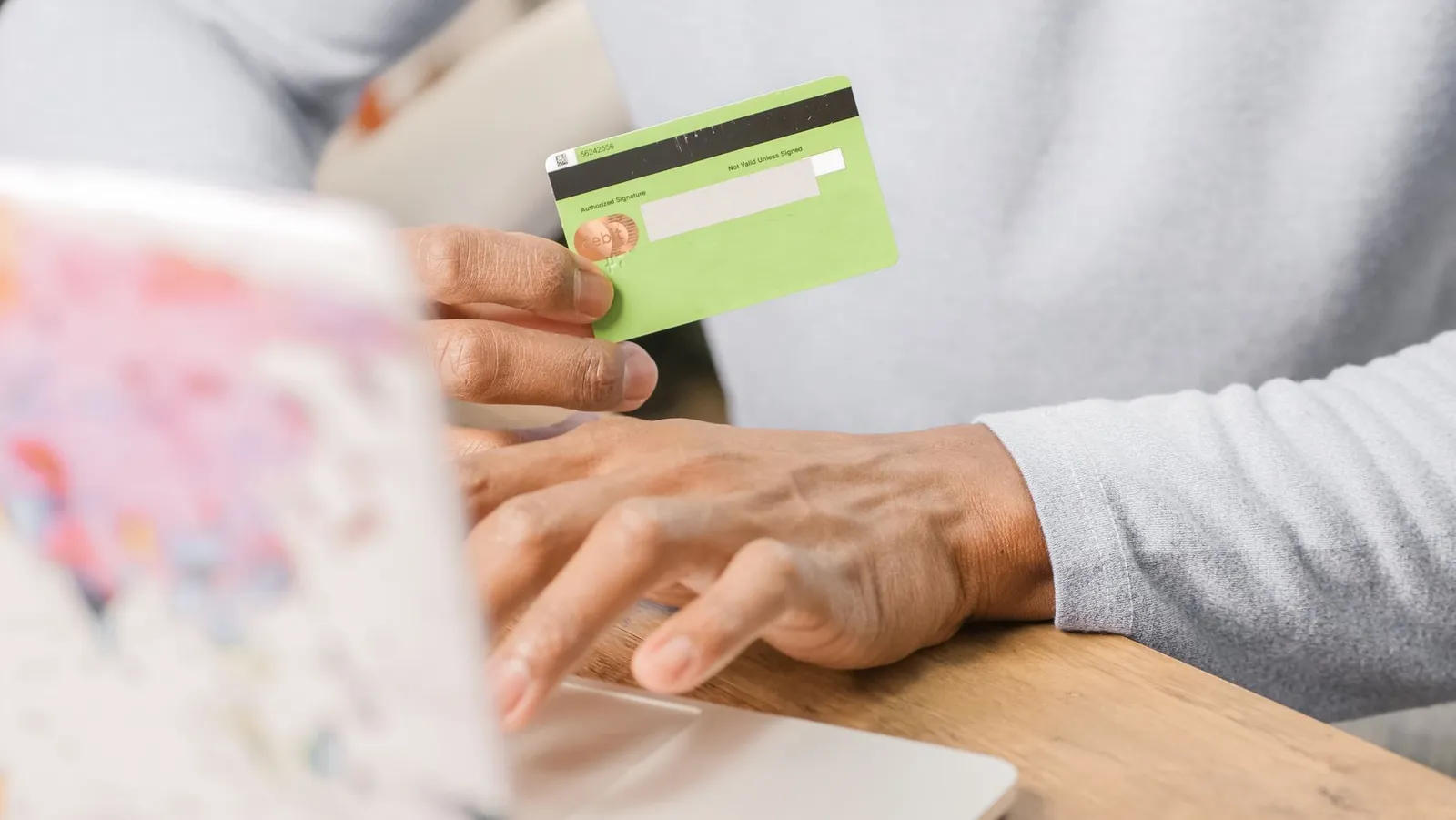 Sealed envelope with a secured credit card and bank deposit slip on financial documents