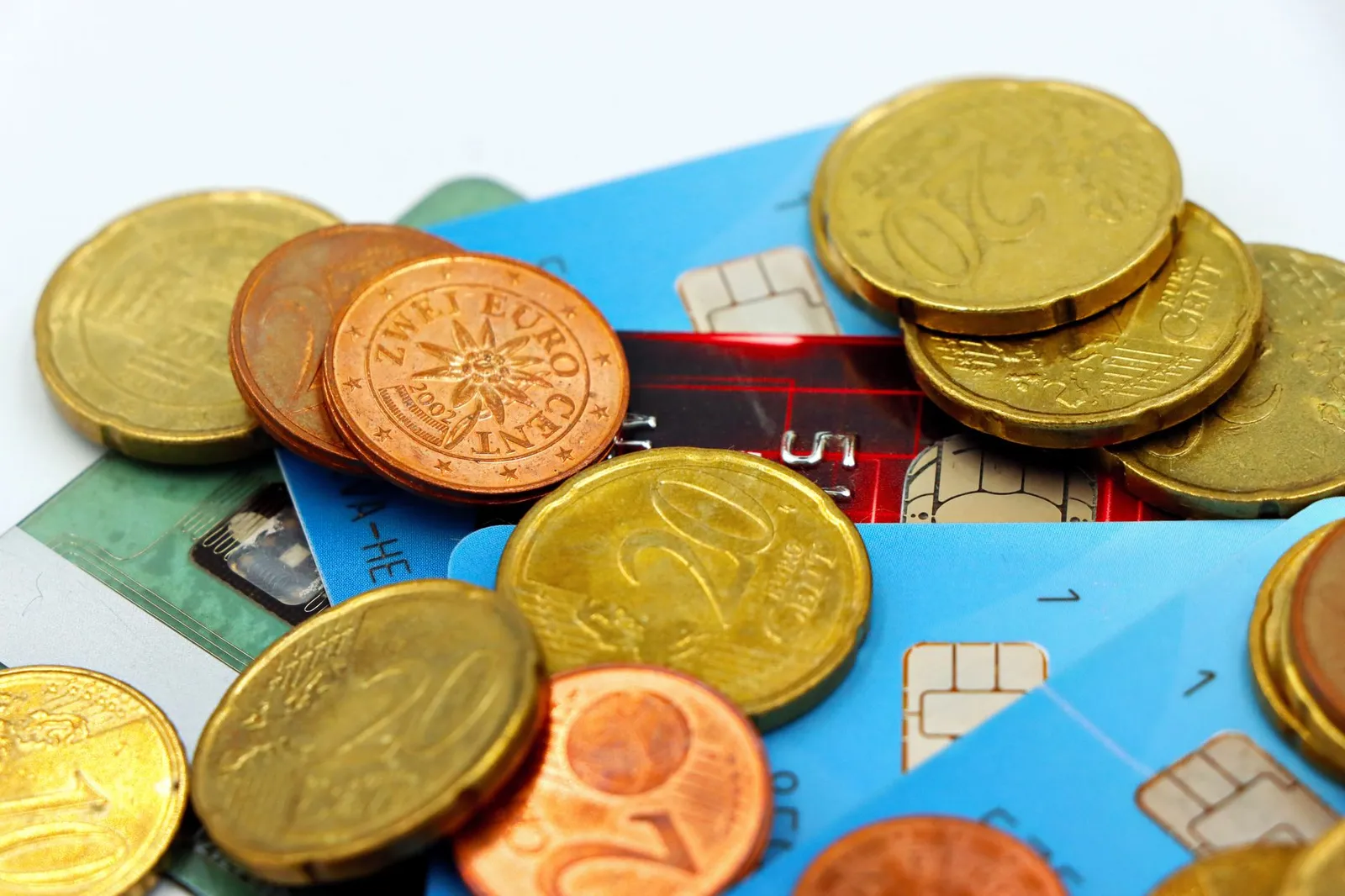 Three different credit cards displayed on a neutral surface with a checkmark icon
