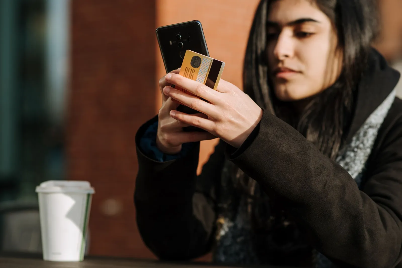 College student with credit card and textbooks in dorm room