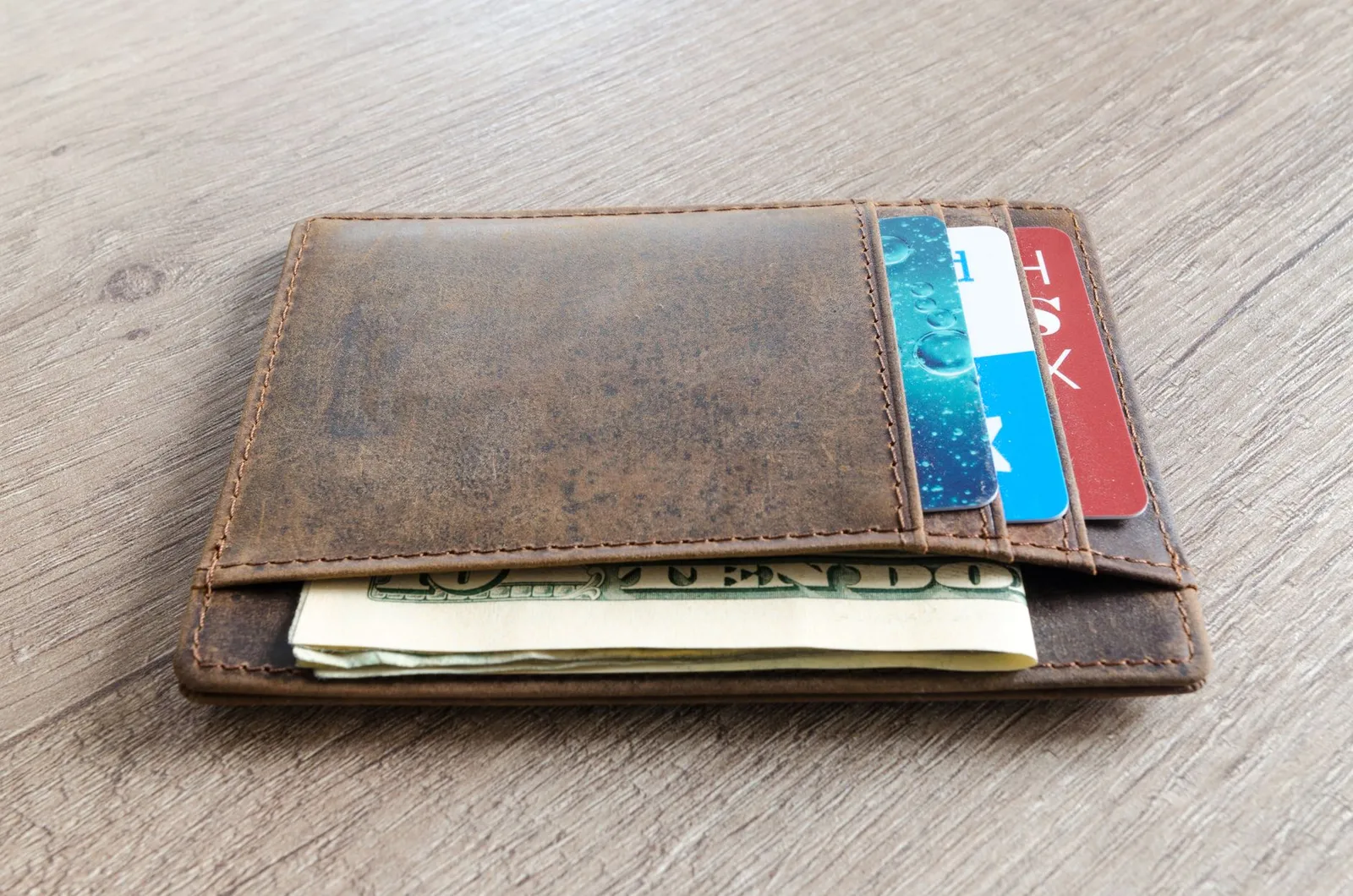 Credit cards arranged with cash showing different deposit amounts