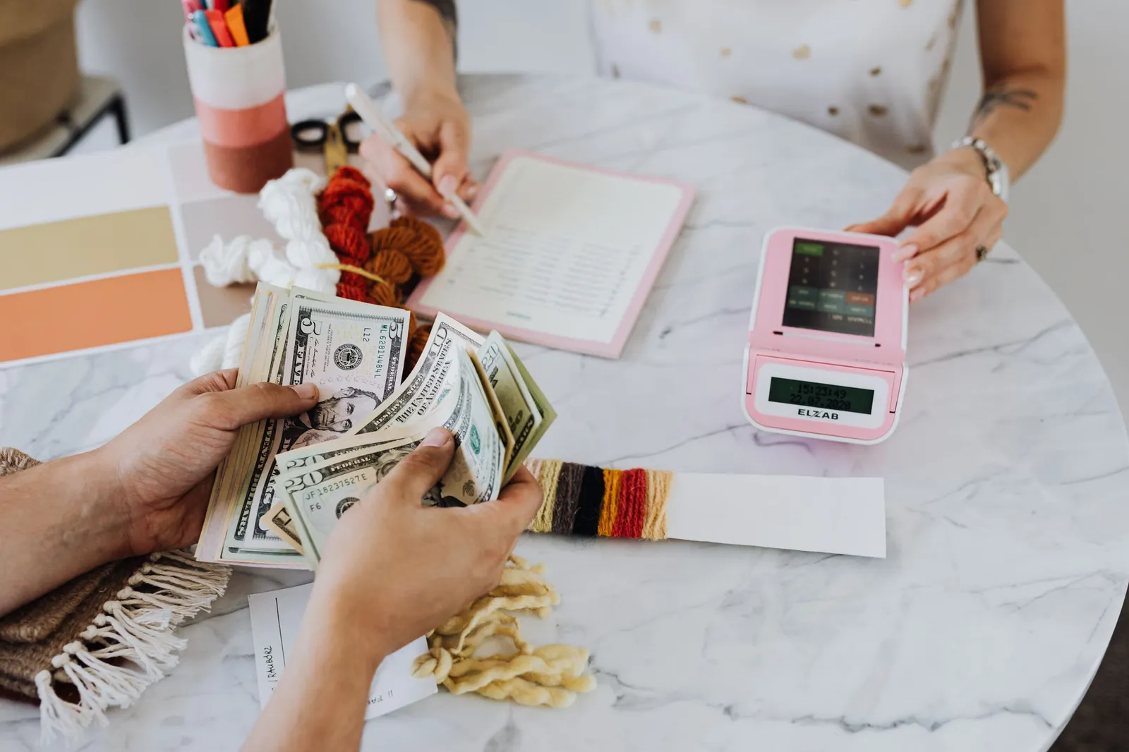 Business receipts, calculator, and cash on desk showing accounting workflow