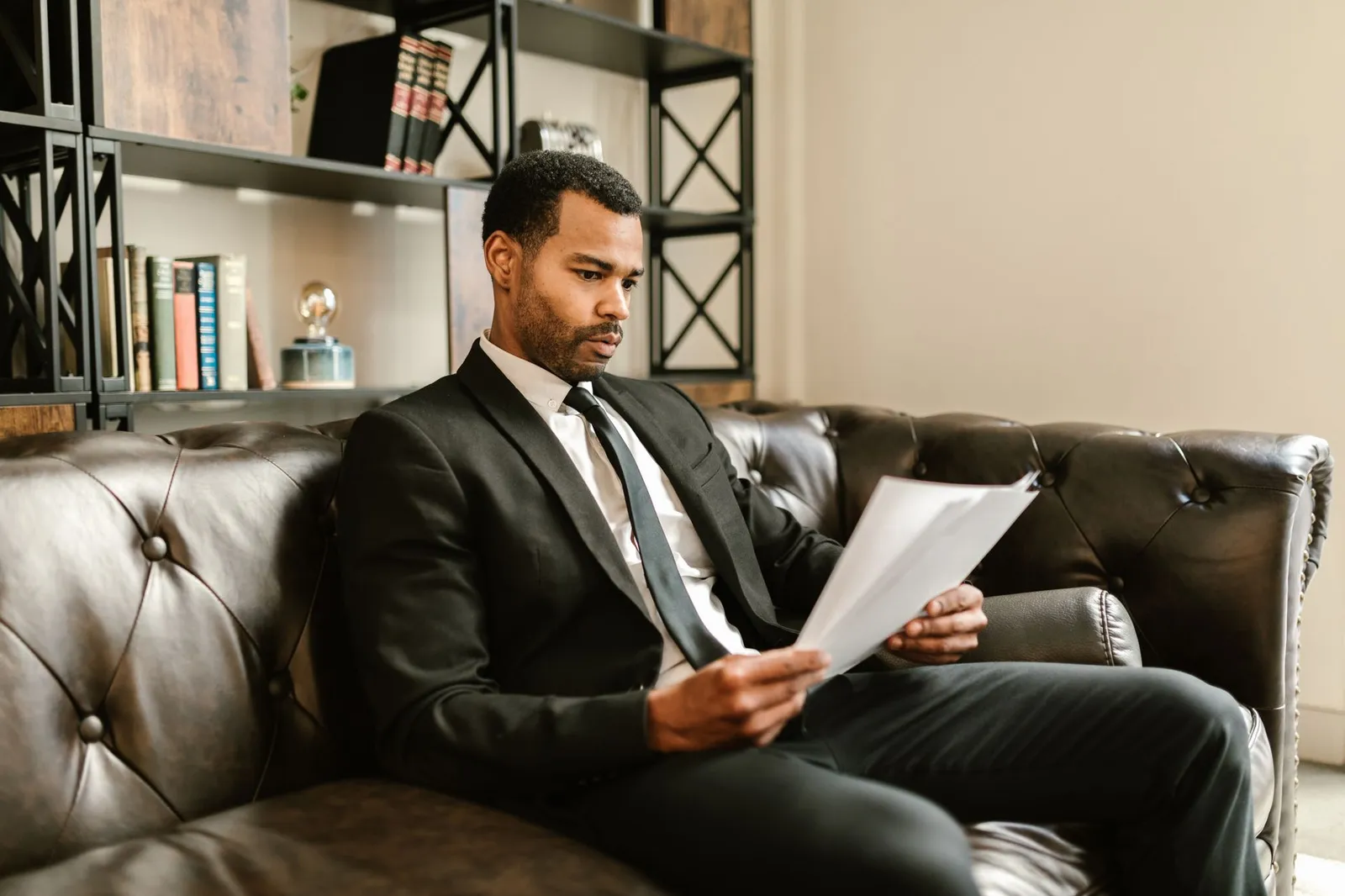 Self-employed business owner reviewing financial documents at home office