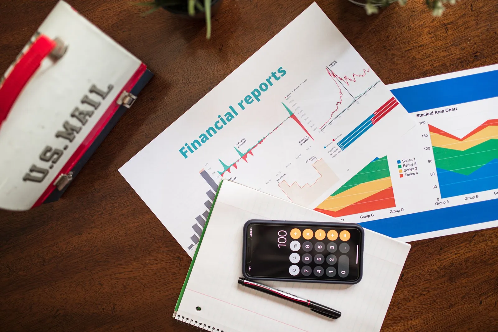 Credit score report and financial documents on desk with calculator