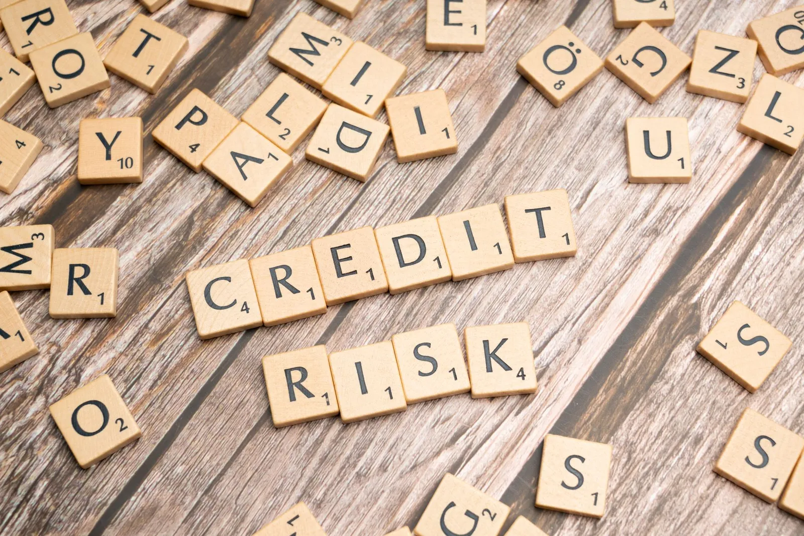 Smartphone showing credit score graph increasing over time with payment reminders